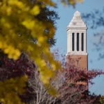 The top of Denny Chimes seen through trees.