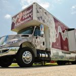 A truck that adapts into a mobile hearing clinic parked.