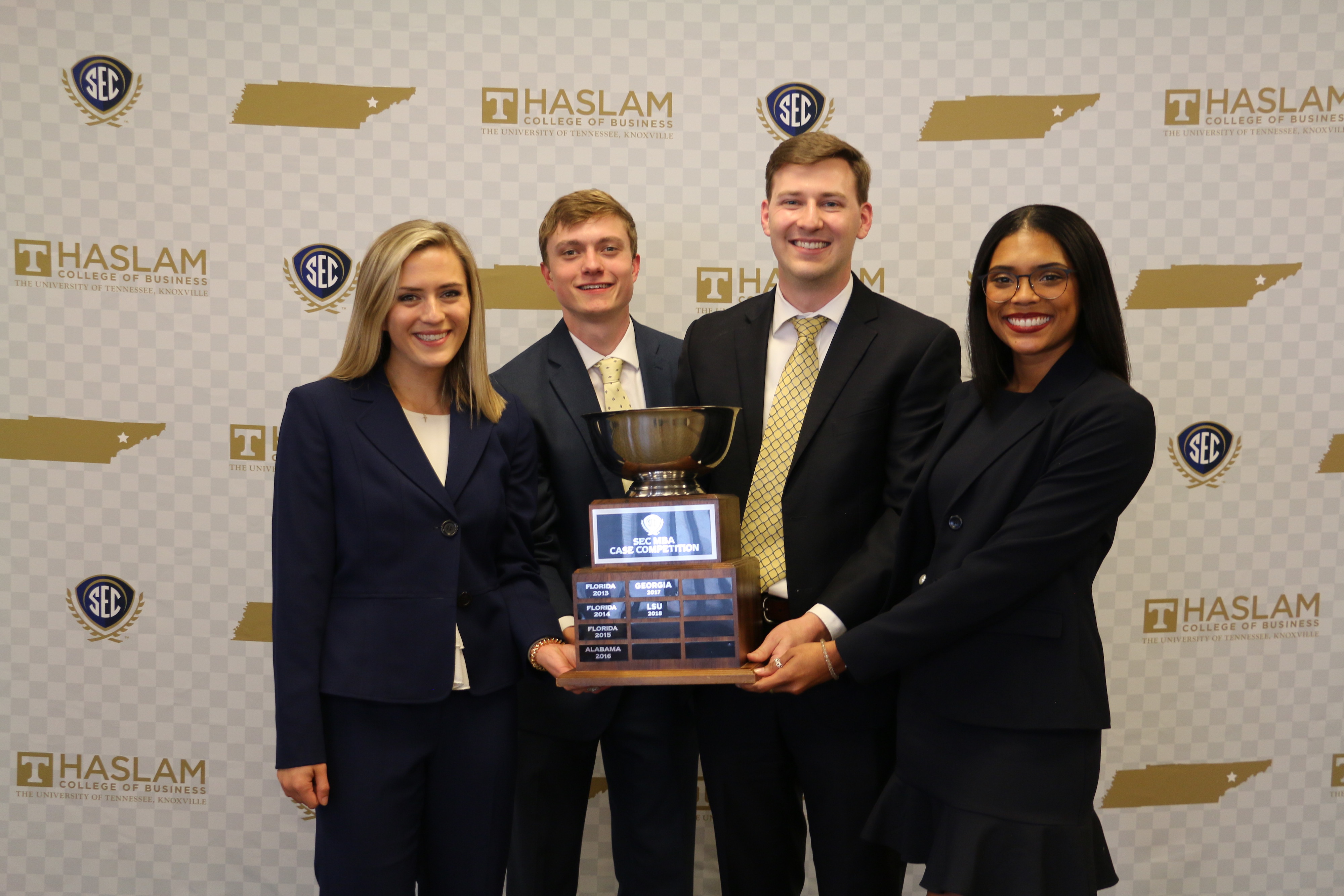The Manderson MBA SEC Case Competition team triumphant with the trophy. L-R: Everette Dawkins, Sam Greene, John Clary, Bryonna Rivera Burrows