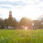 The sun shines onto grass on The University of Alabama campus.