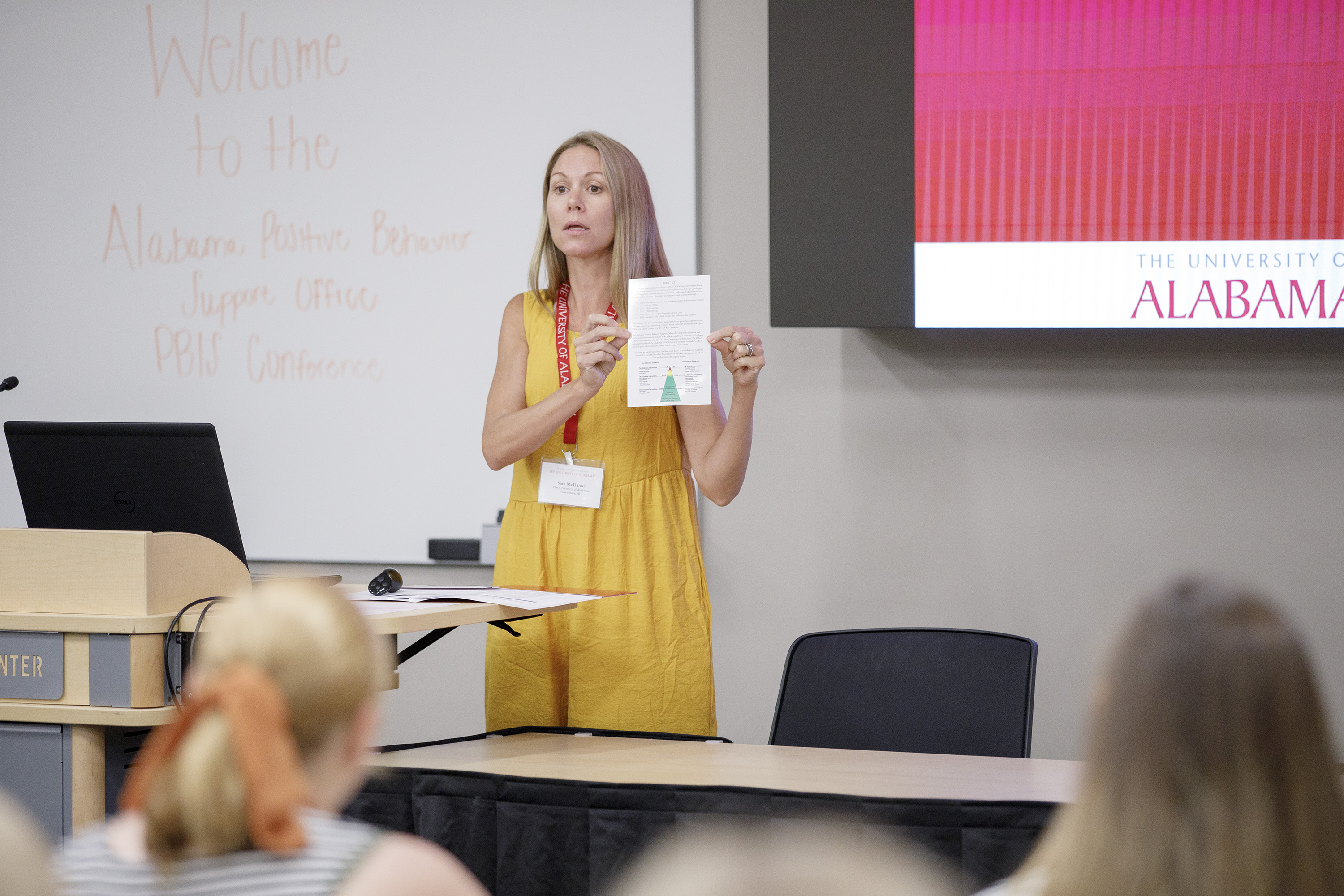 An education researcher speaks to teachers at a conference