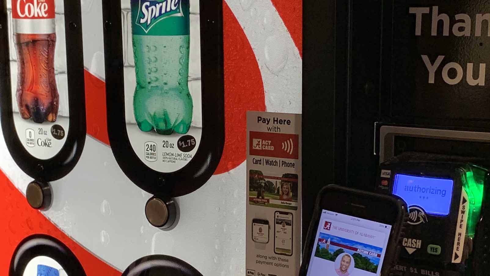 Smart phone held up to a vending machine