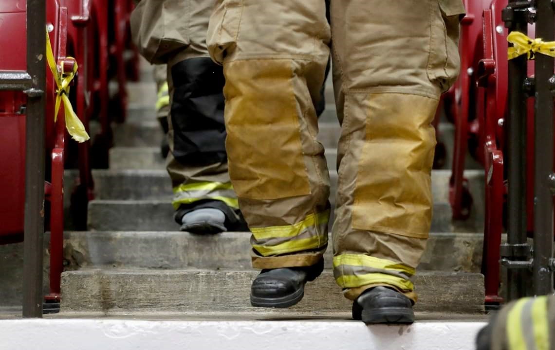 A close up of firefighters' boots descending stairs.