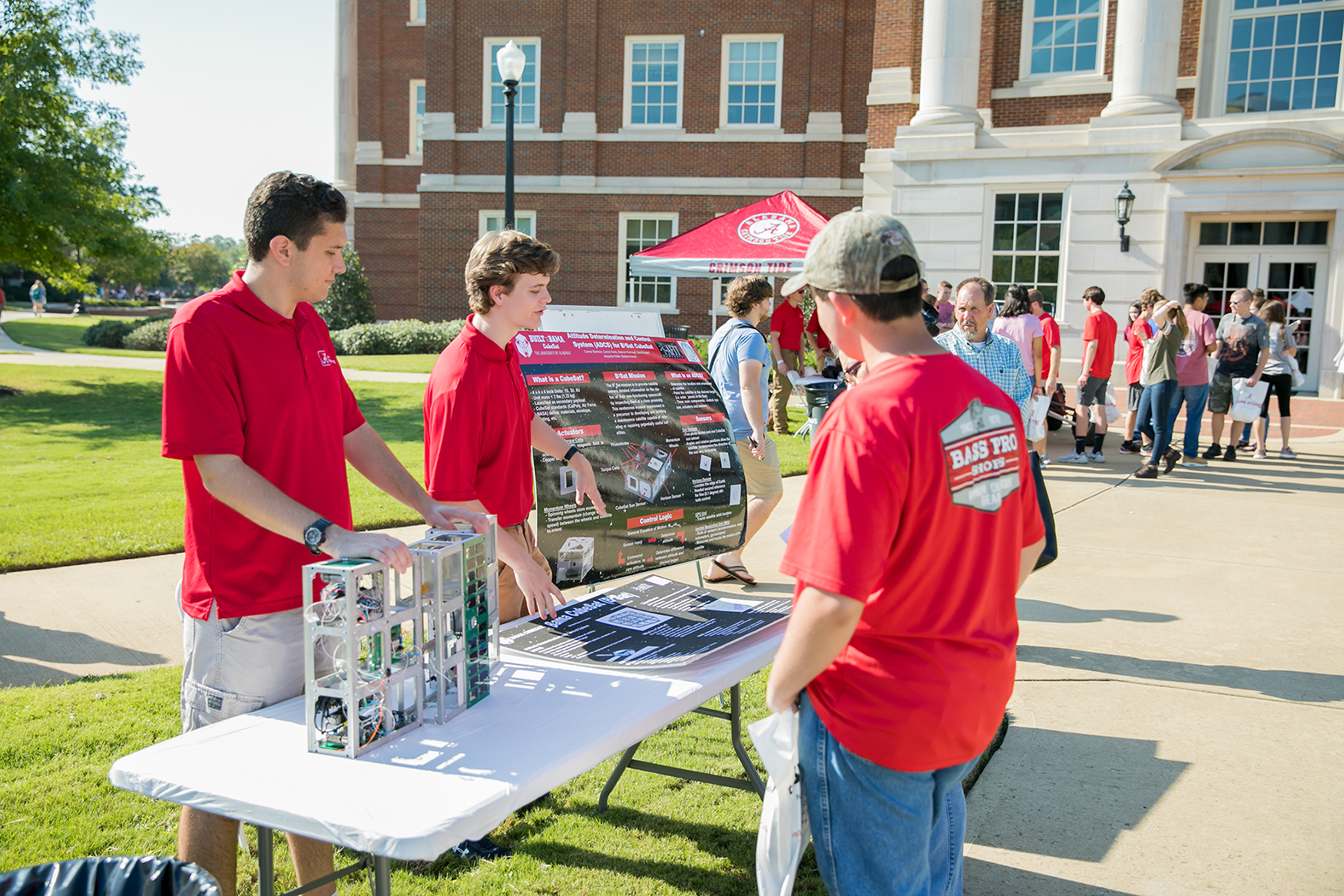 UA students talk with prospective students outside of a campus building.