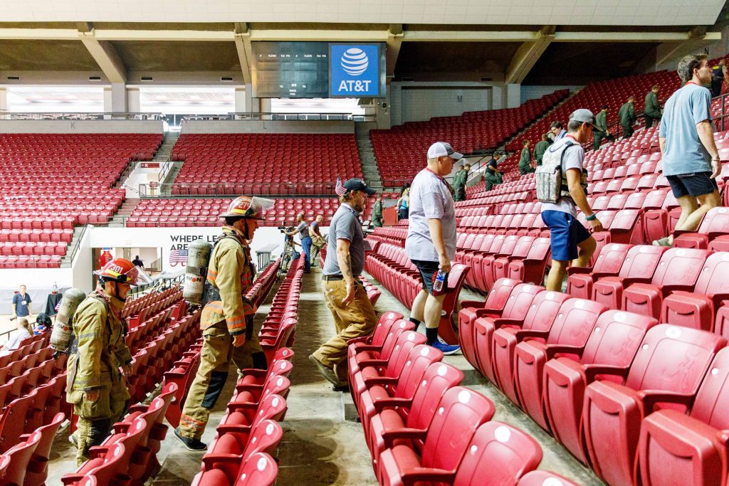 First responders walk up stairs in Coleman Coliseum
