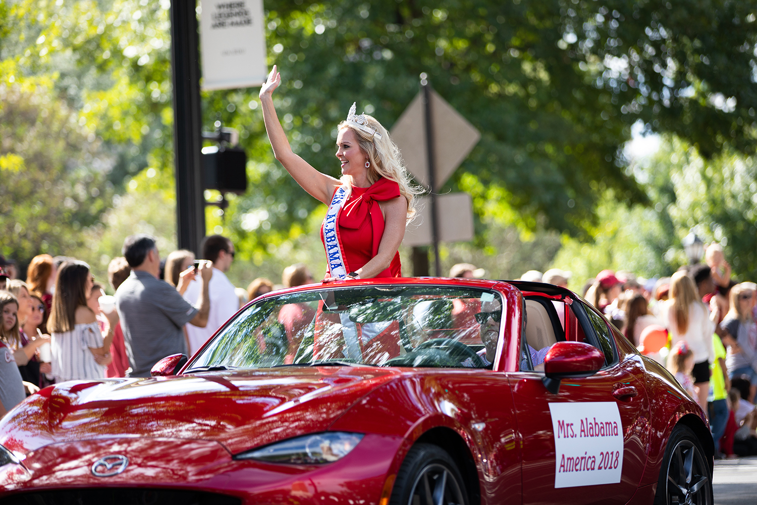 The Homecoming Queen waves from a convertible during the 2018 Homecoming Parade..