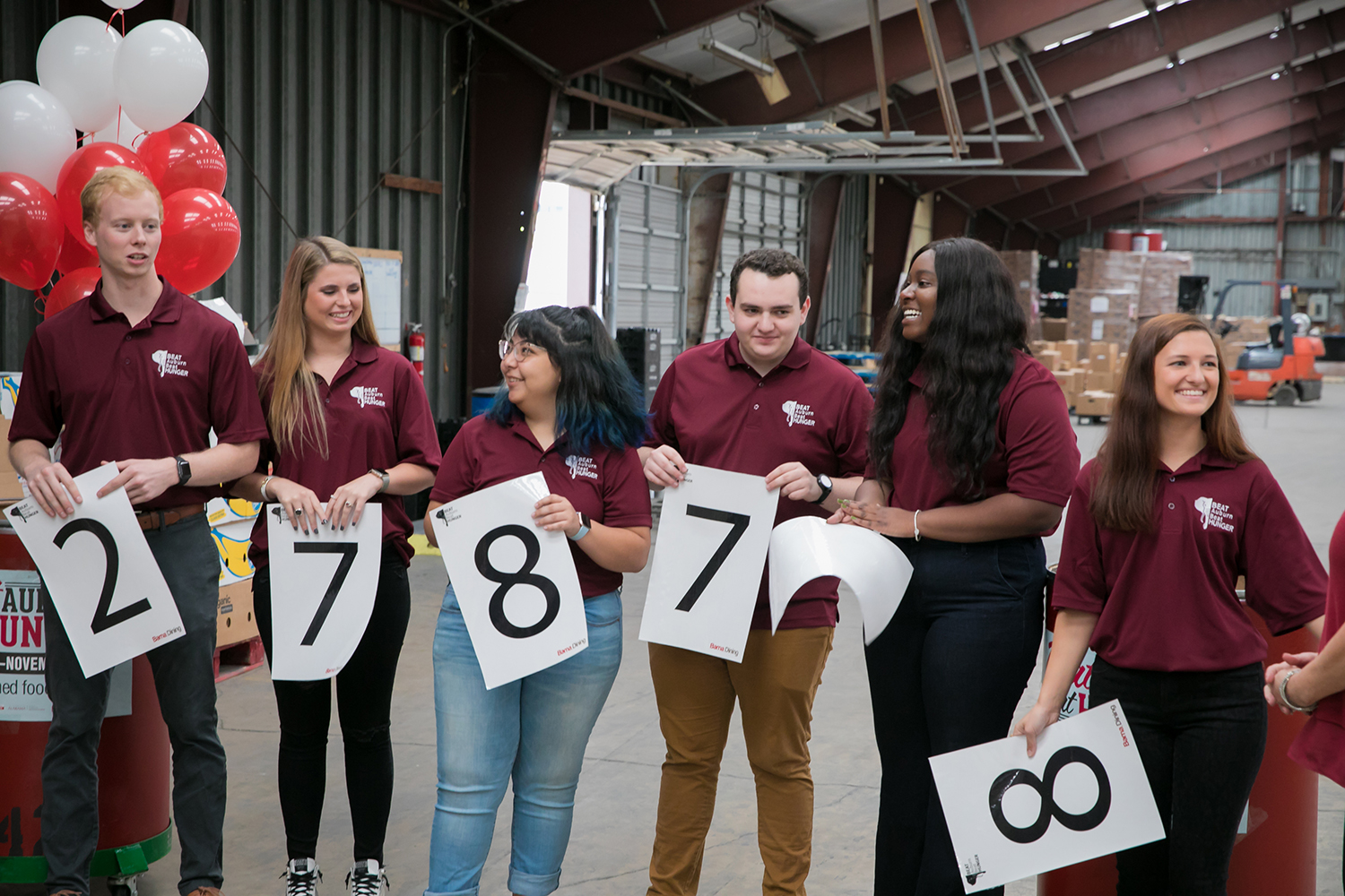 Student staff members of Beat Auburn Beat Hunger reveal the 2019 total using placards.