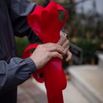Red ribbon being tied