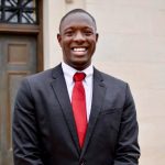 Demarcus Joiner poses in front of Denny Chimes