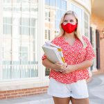 A student wearing a red mask that matches her shirt.