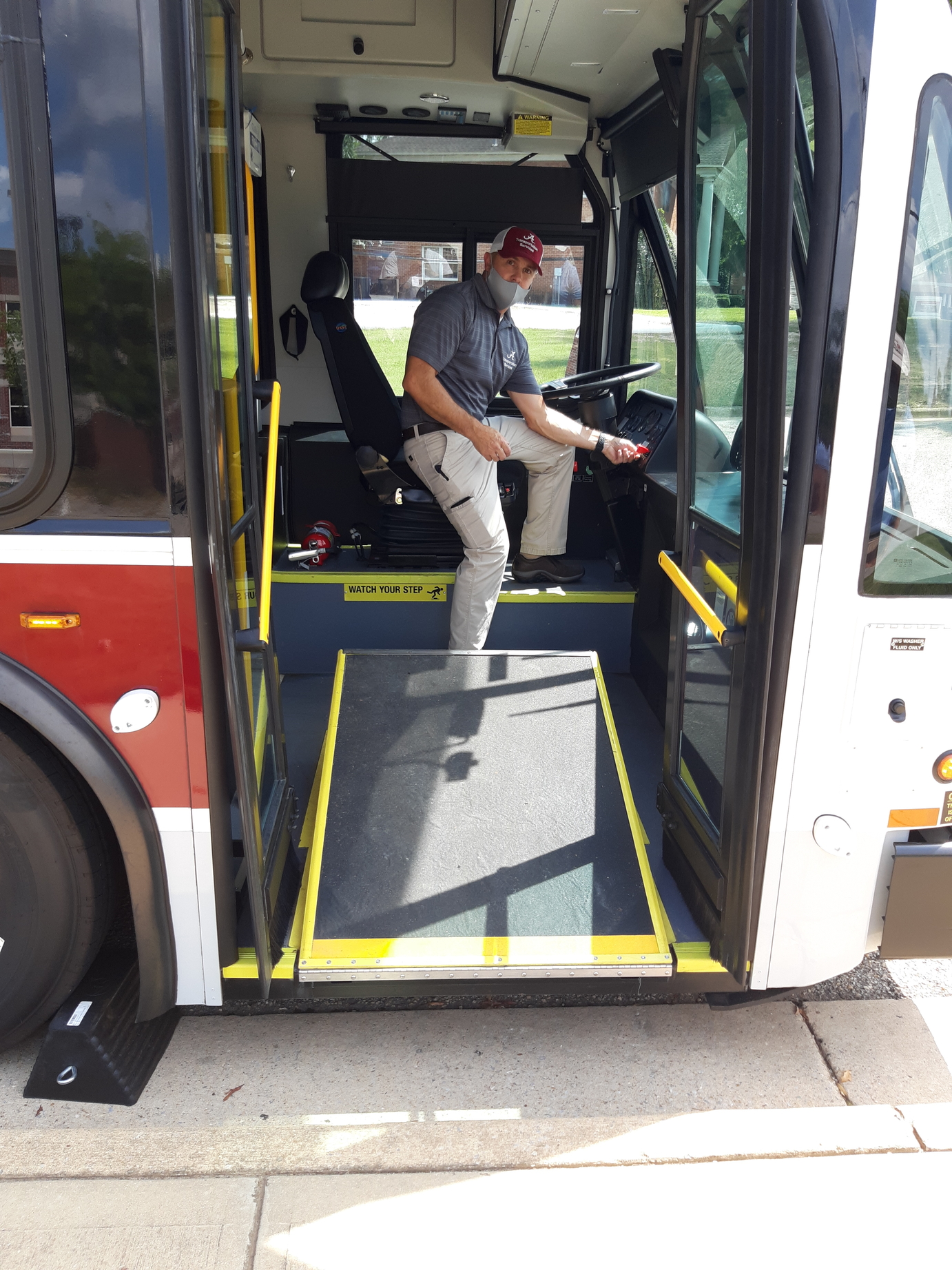Steve Tsapatoris, transit manager, letting down the Crimson Ride handicap accessible ramp