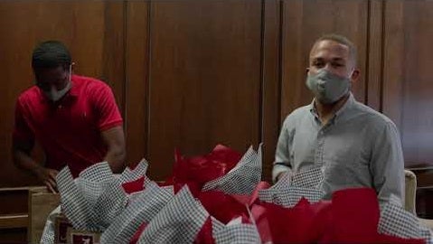 Students fill gift bags on a table
