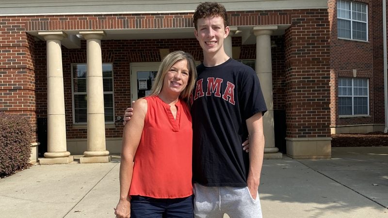 A mom and her freshman son in front of Riverside East.