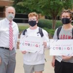 Dr. Bell poses for a picture with two male students for the "Capstone Caught Caring" campaign.