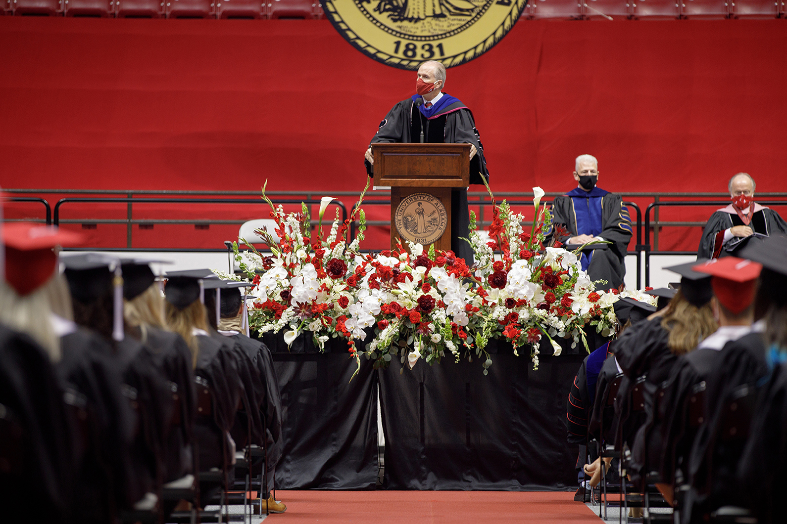 Dr. Bell speaks to students on stage at summer commencement.