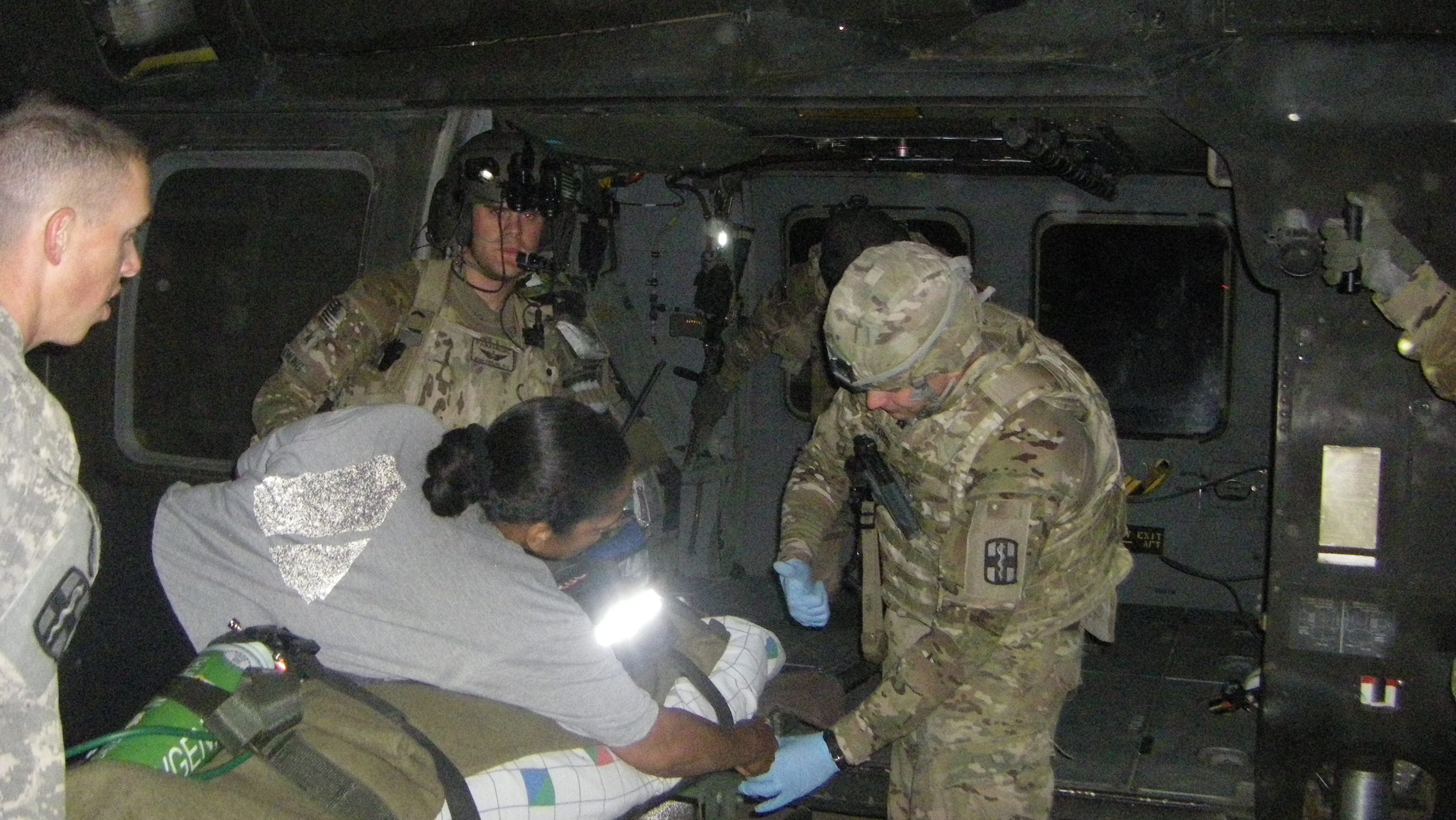 Jacob Caruso transporting a patient on a helicopter in Afghanistan