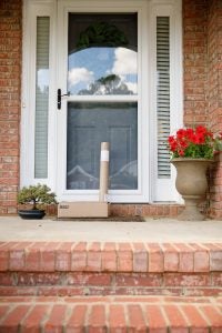 A front door of a home with packages on the door step.
