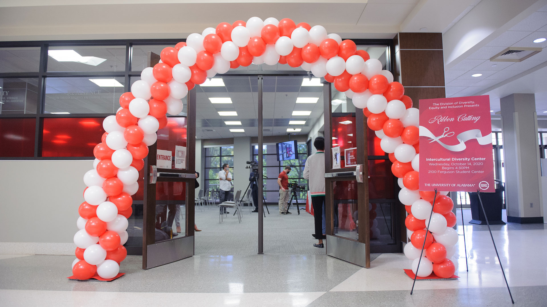 an arch of red and white balloons outside the entrance to the new Intercultural diversity center in the ferguson student center