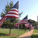 American flags wave on the UA quad.