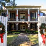 Gorgas House decorated with greenery and red bows