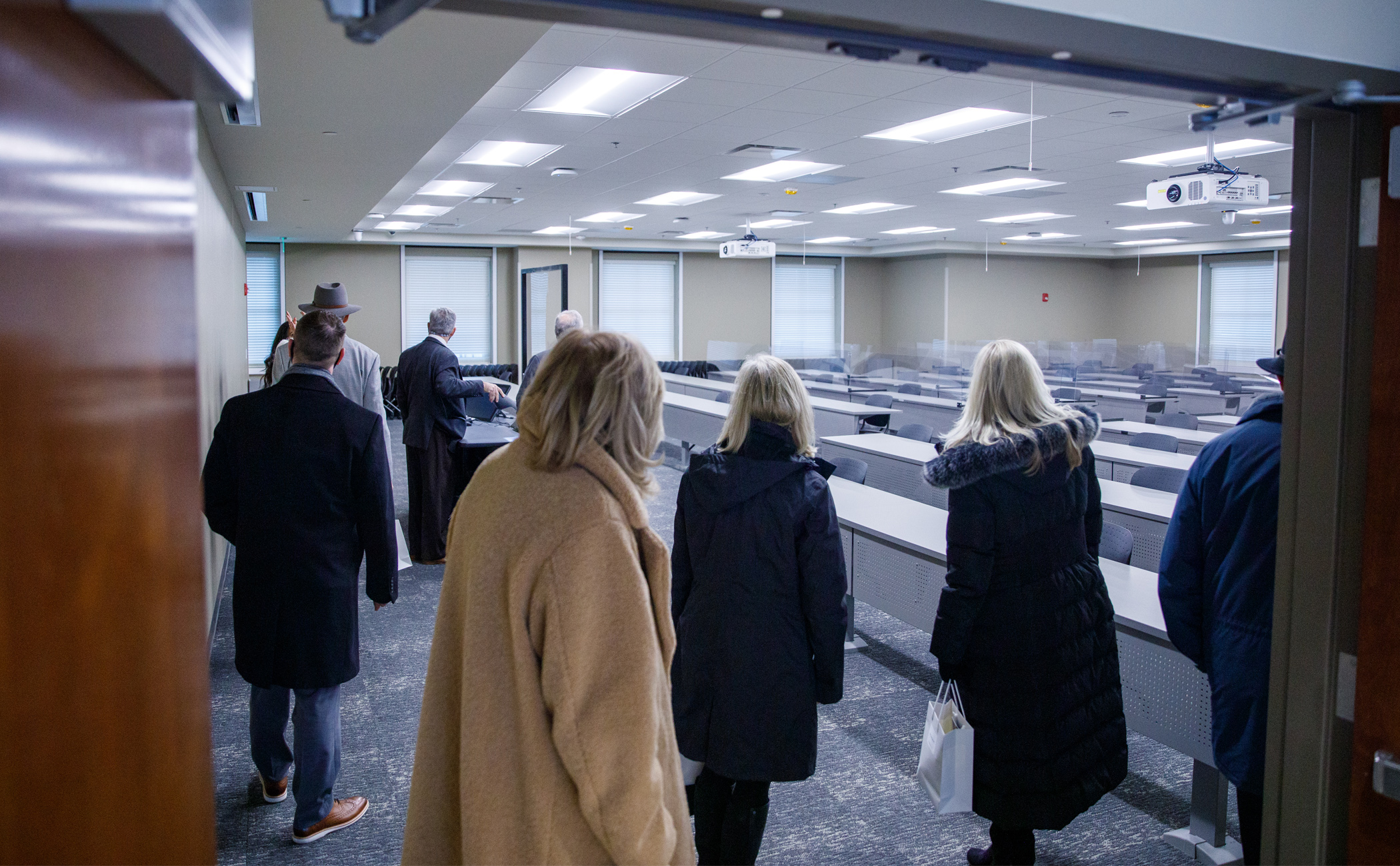 People looking at a new classroom in the addition to the Capstone College of Nursing