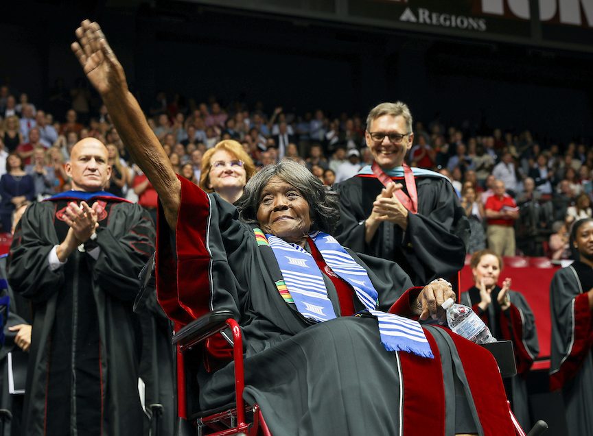 Autherine Lucy foster waves to a standing ovation crowd after receiving an honorary doctorate from UA.