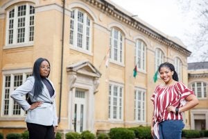 Two UA students stand in front of B.B. Comer Hall. 