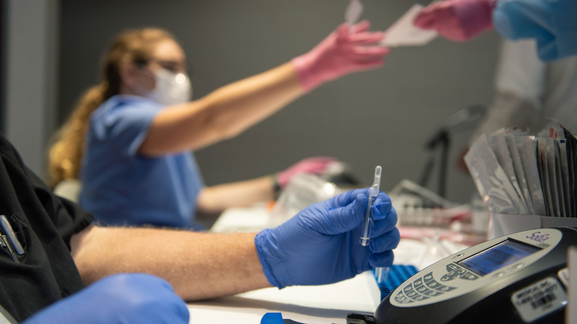 close up of a healthcare worker running a COVID-19 PCR test