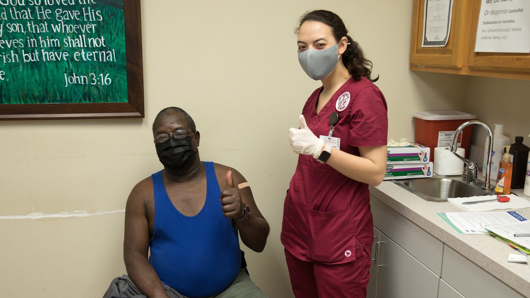 A nursing student and patient giving a thumbs up after the patient received the coronavirus vaccine