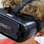 A child wearing goggles that display virtual reality images.