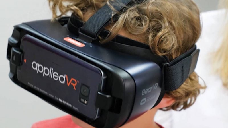 A child wearing goggles that display virtual reality images.