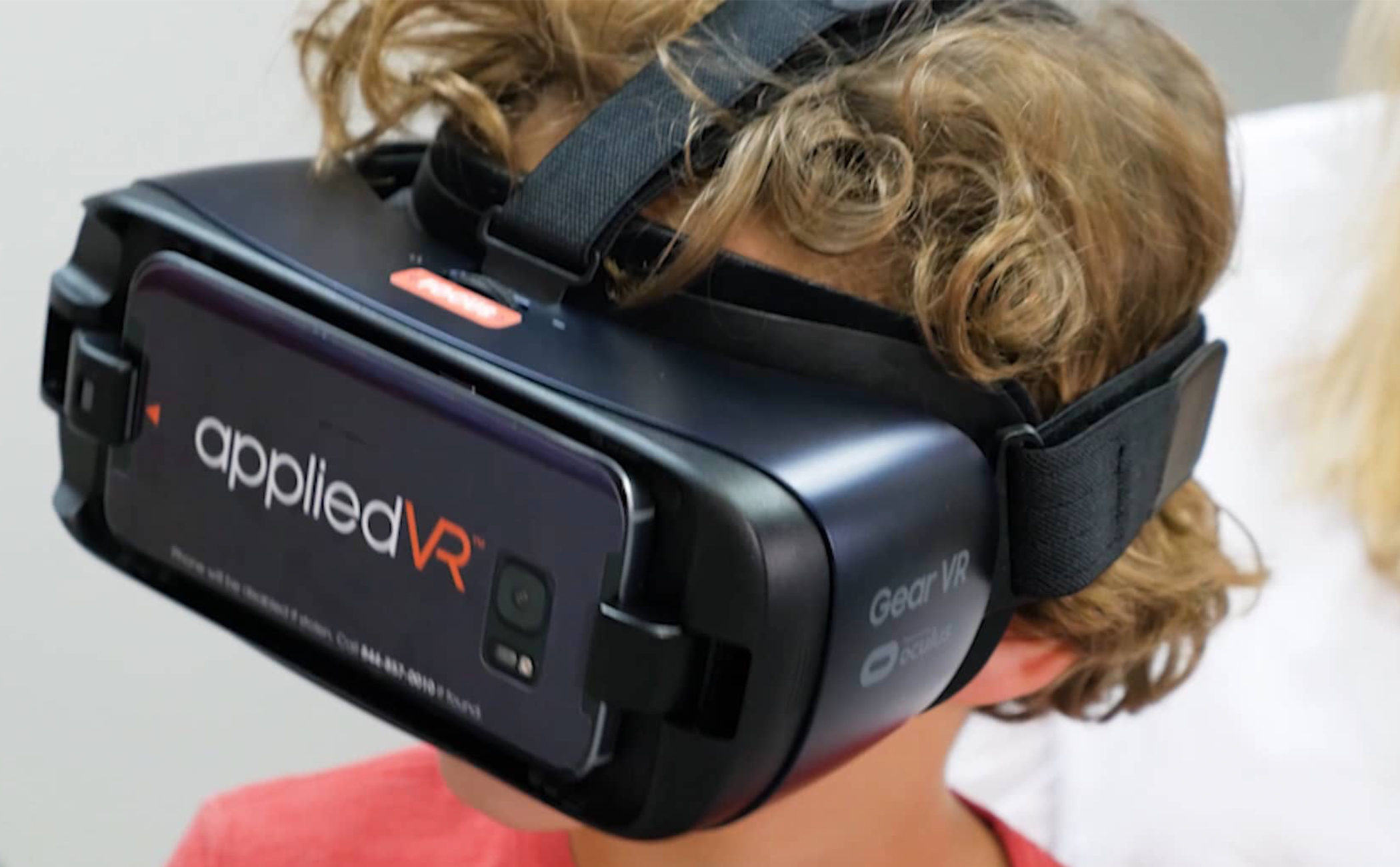 A child wearing goggles that display virtual reality images.