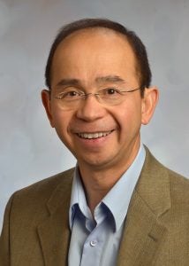 A professional headshot of a man in business attire.