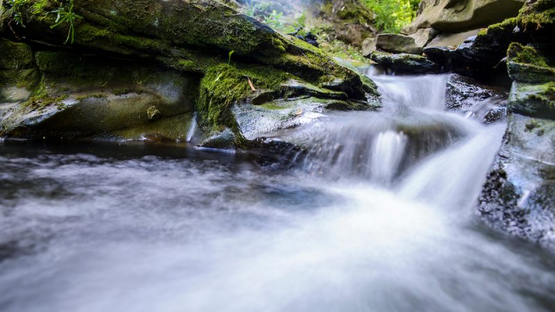 A stream cascades down rocks.