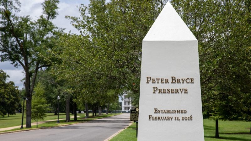 A large obelisk identifying Peter Bryce Preserve at the entrance of the preserve