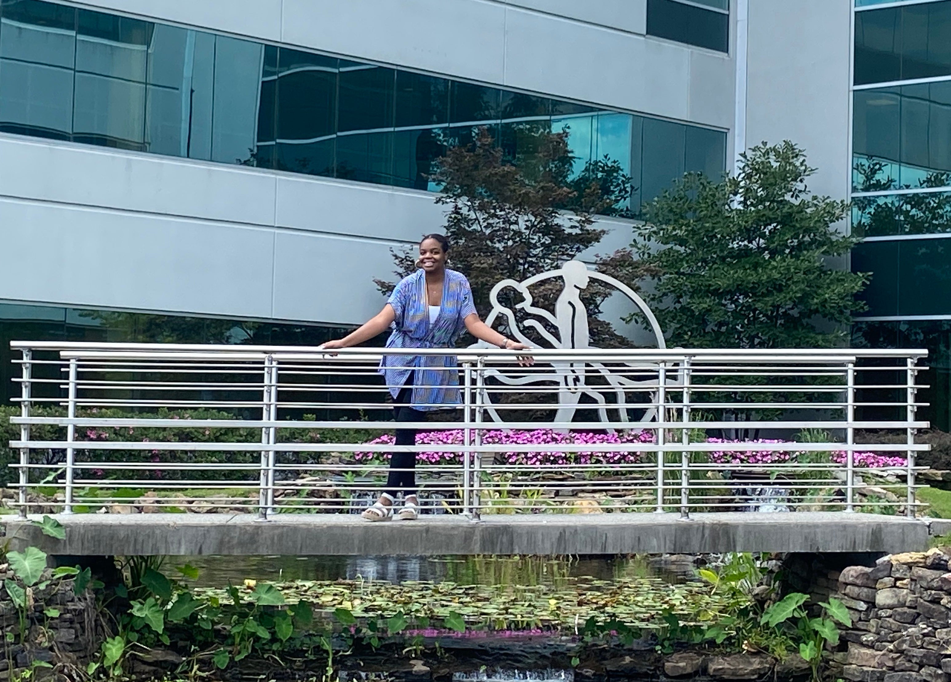 a young woman stands on a bridge at her internship site