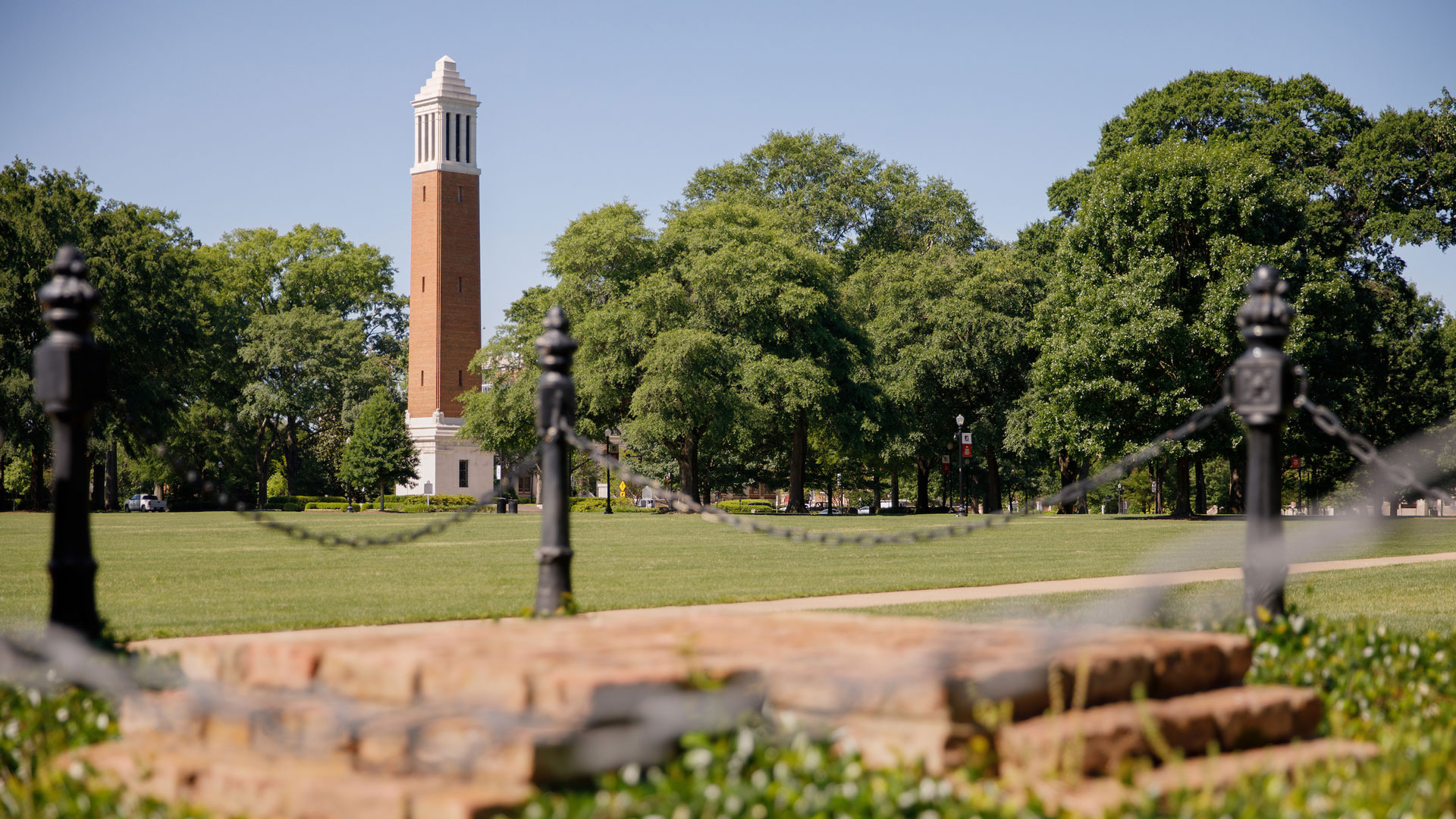 photograph of Denny Chimes and leafy, green trees on the Quad
