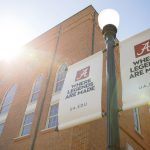 closeup picture of two streetlight banners reading Where Legends Are Made ua.edu