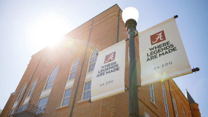closeup picture of two streetlight banners reading Where Legends Are Made ua.edu