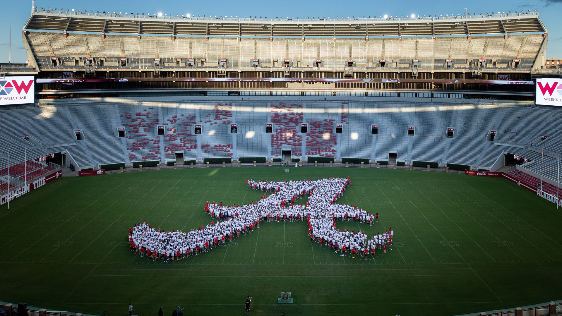 a large script A made up of the freshman 2021 class on the field of Bryant Denny Stadium