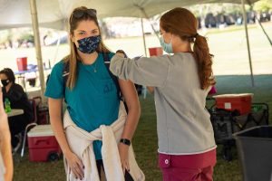 A student receiving a flu shot from a nursing student