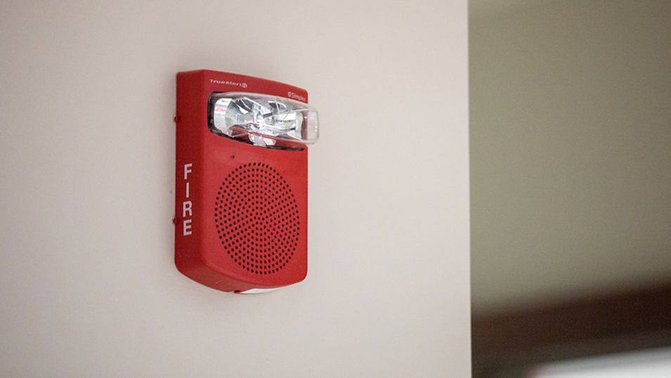 a red fire alarm on a wall