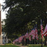 U.S. flags line the Quad with Denny Chimes in the background