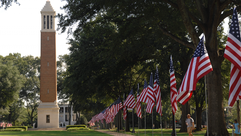 U.S. flags line the Quad with Denny Chimes in the background