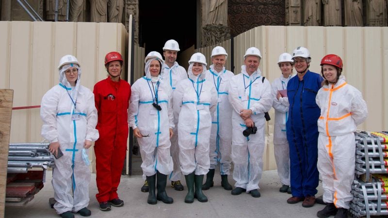 The group of researchers standing in front of the Cathedral of Notre Dame.