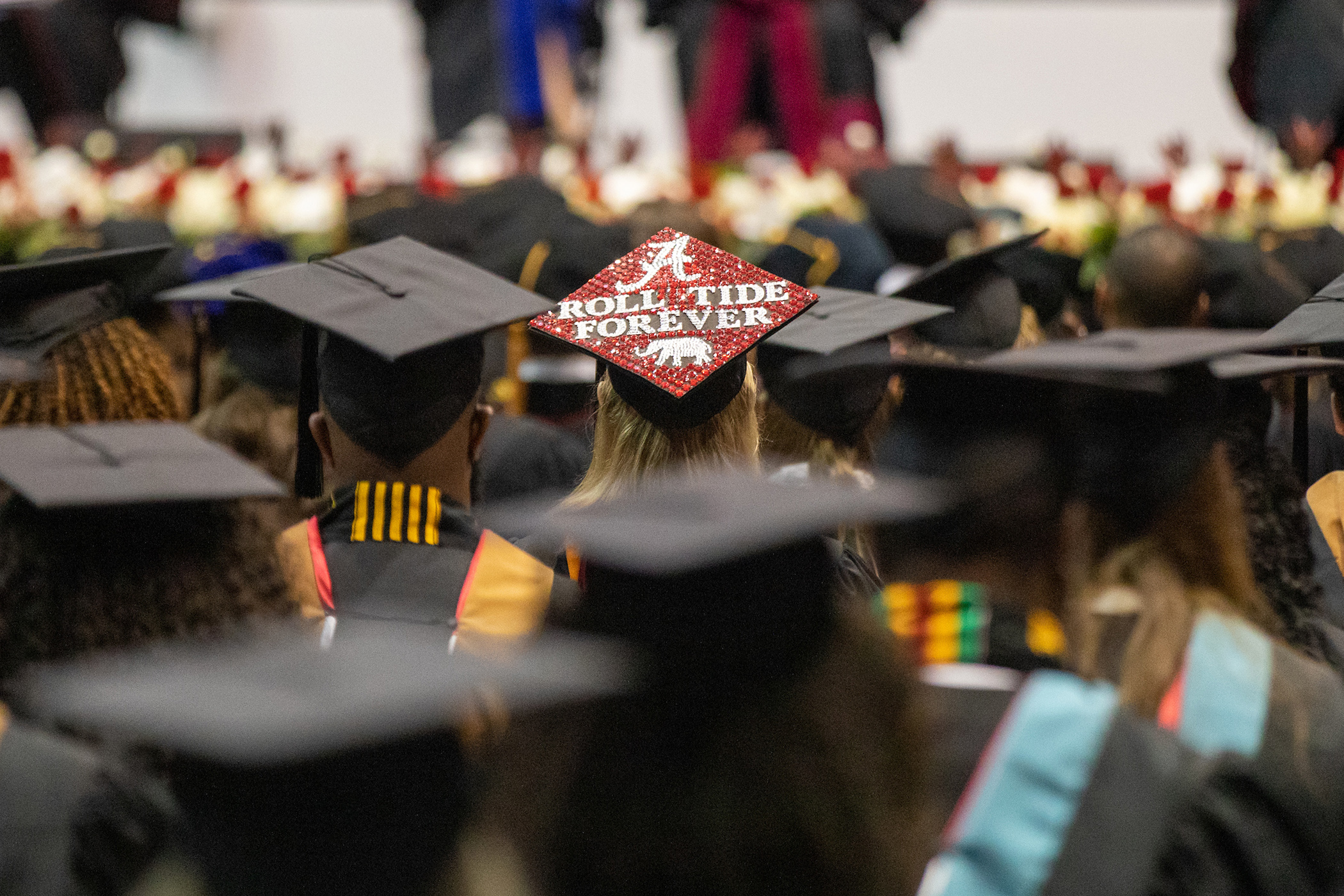A decorated graduation cap that says Roll Tide Forever during spring 2021 commencement