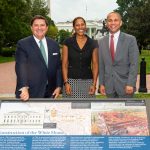 Stewart McLaurin, Hilary West and Royce Dickerson standing behind a Wayside Exhibit panel