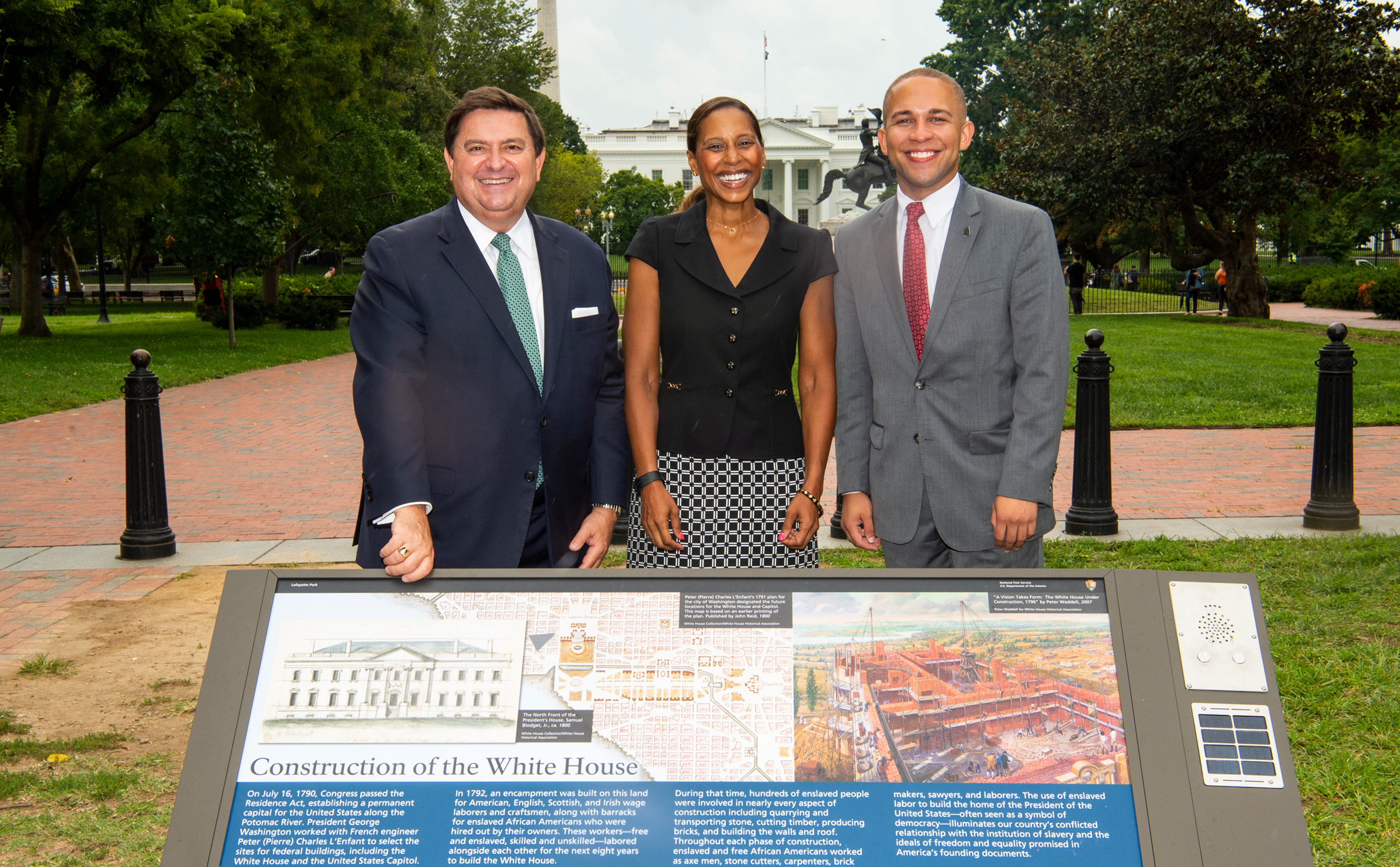 Stewart McLaurin, Hilary West and Royce Dickerson standing behind a Wayside Exhibit panel