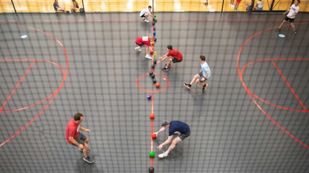 Students play dodgeball in a recreation center.