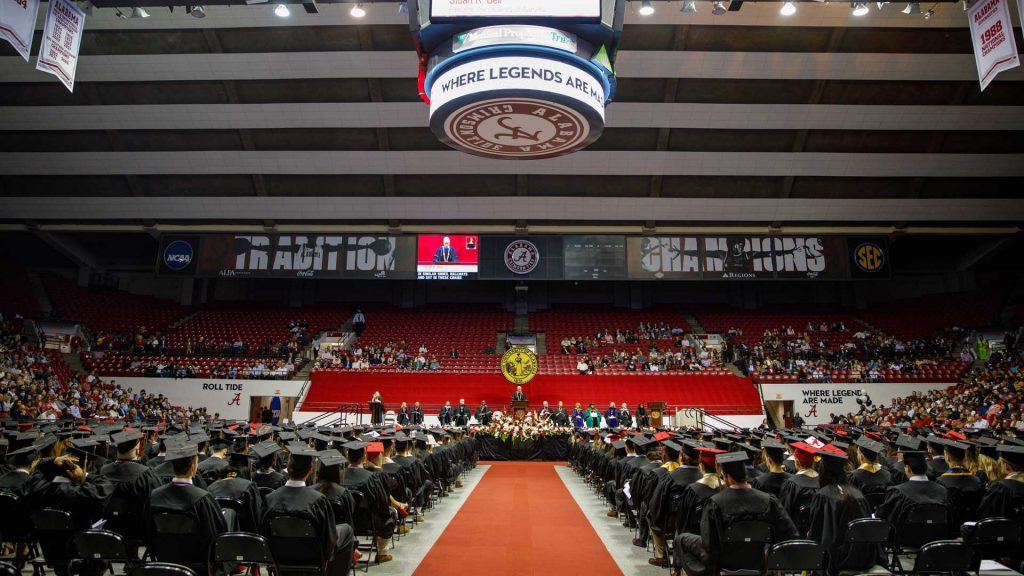 A wide angle view of a graduation ceremony, with students sitting waiting to be awarded degrees.